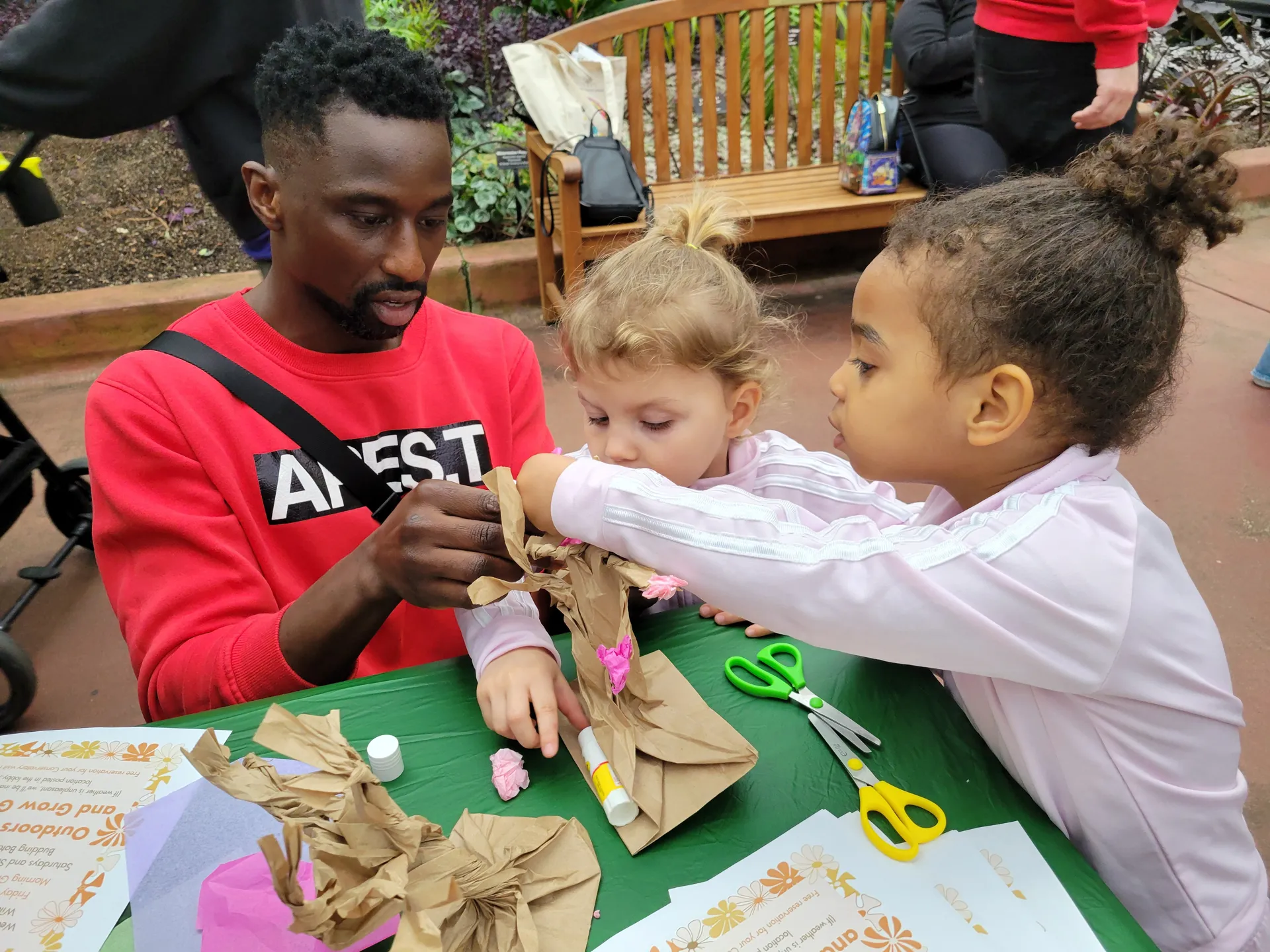 Children and an adult doing an activity together during programming.