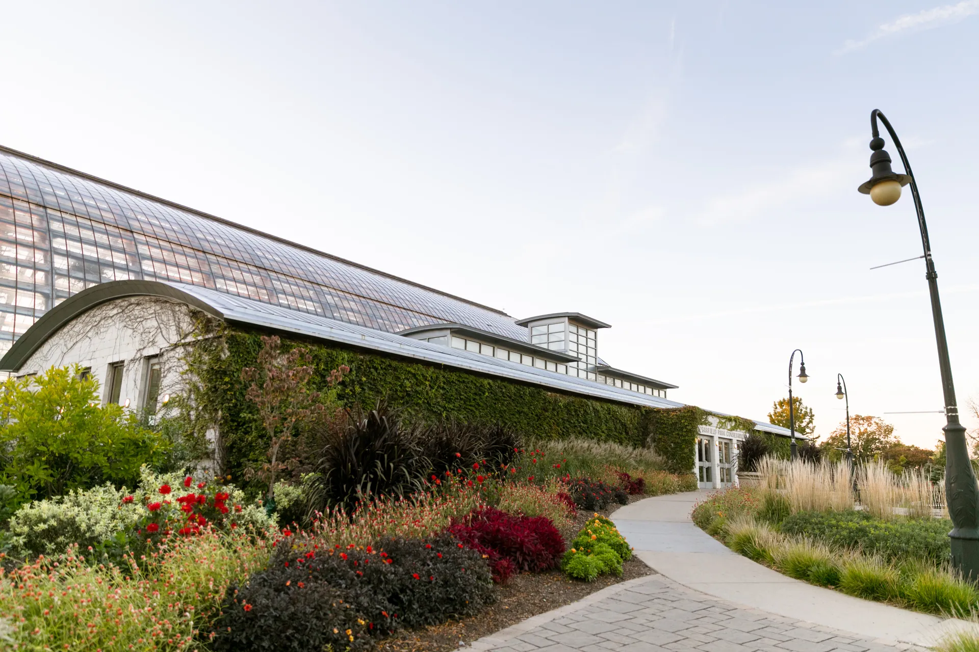Front entrance to the Conservatory show a curved path leading to the doors.