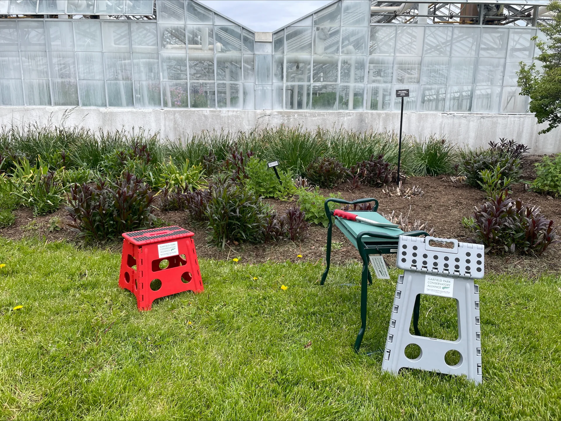 A few of the accessibility tools available for volunteers including different types of portable benches and gardening tools.