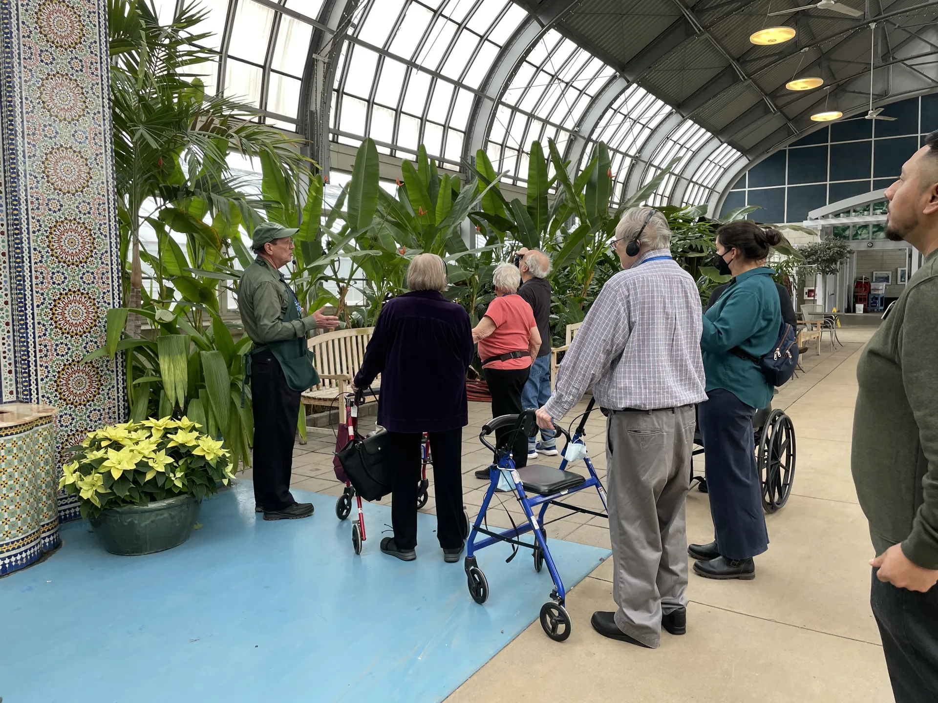 Tour Guide giving a sensory tour to a group in Horticulture Hall