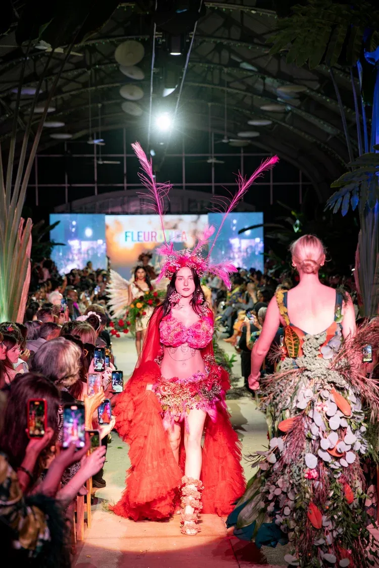 A model in a headdress walks the runway at Fleurotica.